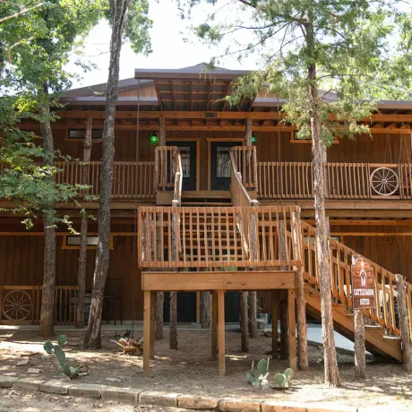 A luxury suite with large windows overlooking a giraffe barn, capturing the unique wildlife experience at Oak Meadow Ranh RV in Valley View, TX.