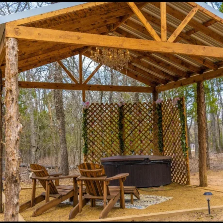 Family gathered around a fire pit at dusk, highlighting the cozy, peaceful ambiance of Oak Meadow Ranch's RV experience in Valley View, TX.