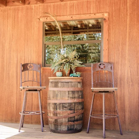 A cozy, wooden cabin nestled in a scenic setting with the sun setting behind it, emphasizing the rustic charm and peaceful atmosphere at Oak Meadow Ranch RV in Valley View, TX.