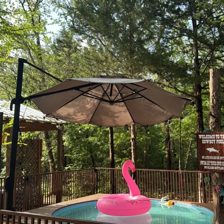 A luxurious hot tub surrounded by lush landscaping, perfect for relaxing after a day of resort activities at Oak Meadow Ranh RV in Valley View, TX.