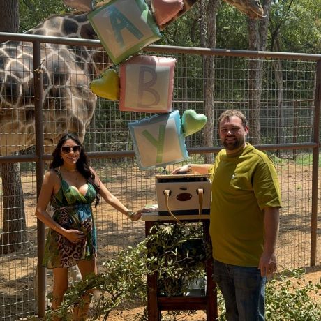 Guests on a safari tour, viewing exotic animals like giraffes, creating a unique wildlife experience at the ranch at Oak Meadow Ranh RV in Valley View, TX.